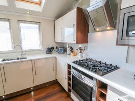 A kitchen with a gas stove and kitchen cabinets at 37 Horizon Park in Hartlepool