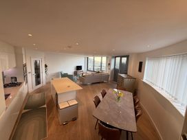 A living room with a dining table and sofa at Apartment 29 in Newquay