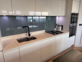 A kitchen with a sink and gas stove at Apartment 29 in Newquay