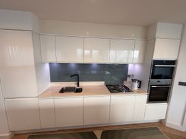A kitchen with a sink and gas stove at Apartment 29 in Newquay