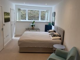 A bedroom with a bed and side table at Apartment 29 in Newquay