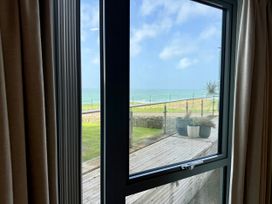 A view from a window showing a deck and sea at Apartment 29 in Newquay