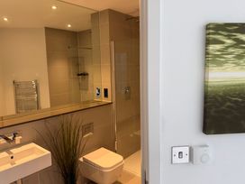 A bathroom with a sink, toilet, and shower at Apartment 29 in Newquay