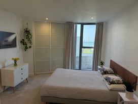 A bedroom with a bed and dresser at Apartment 29 in Newquay