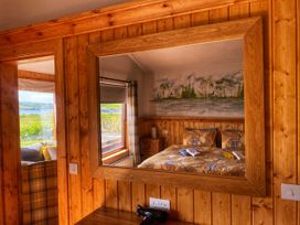 A bedroom with a bed and a mirror at No 4 in Enniskillen
