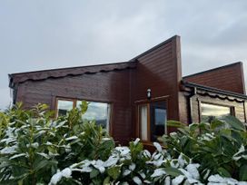 A house with windows and bushes covered in snow at No 4 Enniskillen