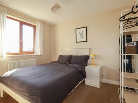 A bedroom with a bed and window at Carnweather in Newquay