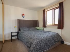 A bedroom with a bed and bedside table at Carnweather in Newquay
