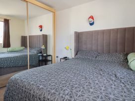 A bedroom with a bed and bedside table at Carnweather in Newquay