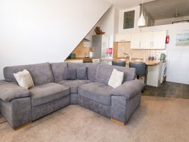 A living room with a sofa and kitchen in Chandlers Nook Portland