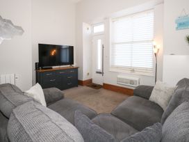 A living room with a television and sofa at Chandlers Nook in Portland