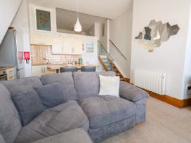 A living room with a sofa and kitchen area at Chandlers Nook in Portland