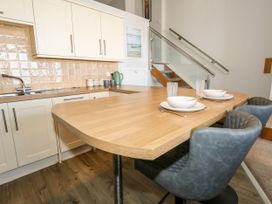 A kitchen with a dining table and chairs at Chandlers Nook in Portland