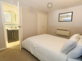 A bedroom with a bed and access to a bathroom at Chandlers Nook in Portland