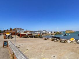 A waterfront view with boats and benches at Chandlers Nook in Portland