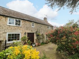 A cottage exterior with garden plants at The Annexe at Cherry Cottage Upton St Leonards
