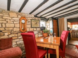 A dining room with a table and chairs at The Annexe at Cherry Cottage Upton St Leonards