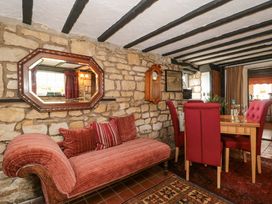 A dining room with a sofa and dining table at The Annexe at Cherry Cottage Upton St Leonards