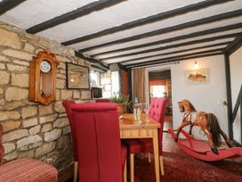 A dining room with a table and chairs at The Annexe at Cherry Cottage Upton St Leonards