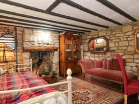 A living room with a bed and sofa at The Annexe at Cherry Cottage in Upton St Leonards