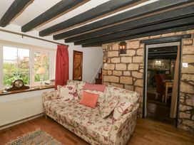 A living room with a sofa and lamp at The Annexe at Cherry Cottage Upton St Leonards