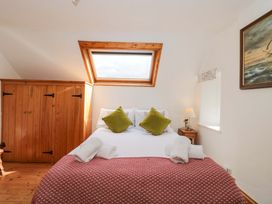 A bedroom with a bed and storage space at The Annexe at Cherry Cottage Upton St Leonards