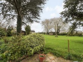 A garden with grass and trees at The Annexe at Cherry Cottage Upton St Leonards