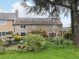 A garden with seating area and greenery at The Annexe at Cherry Cottage Upton St Leonards