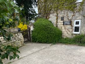 An outdoor area with a bush and stone wall at The Annexe at Cherry Cottage Upton St Leonards