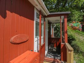 An entrance area with a door and a bench at Chalet 47 Erw Porthor in Tywyn