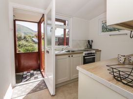 A kitchen with sink and stove at Chalet 47 Erw Porthor Tywyn