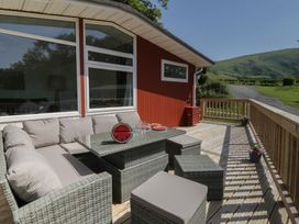 An outdoor seating area with a sofa and table at Chalet 47 Erw Porthor Tywyn