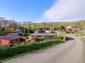 A view of cabins along a road in an outdoor area at Chalet 23 Erw Porthor Tywyn