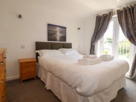 A bedroom with a bed and nightstand at 62 Golf Lodges Atlantic Reach near Fraddon
