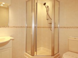 A bathroom featuring a shower, toilet, and sink at 62 Golf Lodges, Atlantic Reach near Fraddon