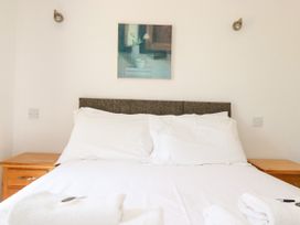 A bedroom with a bed and nightstand at 62 Golf Lodges Atlantic Reach near Fraddon