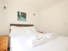 A bedroom with a bed and towels on a nightstand at 62 Golf Lodges Atlantic Reach near Fraddon