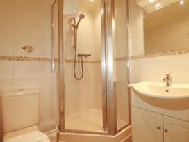 A bathroom with a shower, sink, and toilet at 62 Golf Lodges Atlantic Reach near Fraddon
