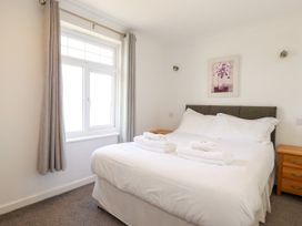 A bedroom with a bed and window at 62 Golf Lodges, Atlantic Reach near Fraddon