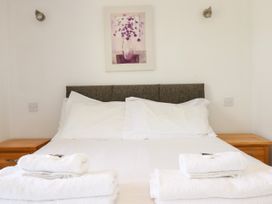 A bedroom with a bed and towels at 62 Golf Lodges, Atlantic Reach near Fraddon