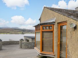 A house with windows overlooking a lake at Wilders Wood in Windermere