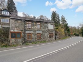 A stone building next to a road at Wilders Wood in Windermere
