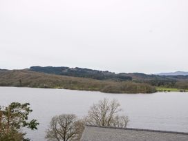 A view of a lake surrounded by trees and hills at Wilders Wood Windermere