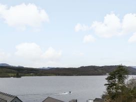 A view of a lake with a boat in the water at Wilders Wood Windermere