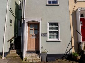 An entrance with a door and a sign at Phoenix Cottage in Lyme Regis