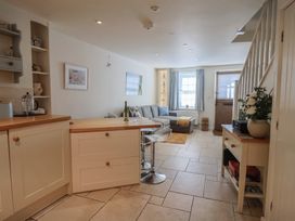 A living room with a couch and dining table at Phoenix Cottage in Lyme Regis