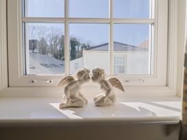 Two figurines on a window sill at Phoenix Cottage in Lyme Regis