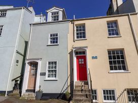A house exterior with a blue and yellow facade at Phoenix Cottage in Lyme Regis