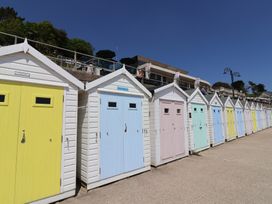 A row of colorful beach huts at Phoenix Cottage in Lyme Regis