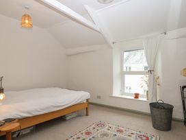 A bedroom with a bed and a window at Bedford Cottage in Yelverton